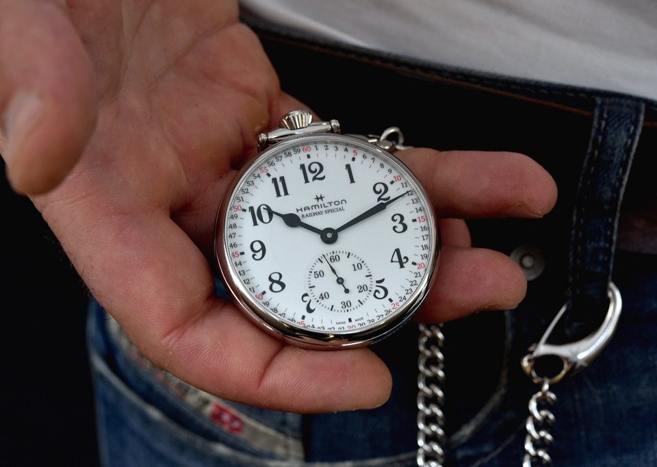 wearing a pocket watch with a suit