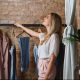 Woman sorting clothes on a clothing rack