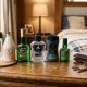 Three modern mens cologne bottles arranged on a textured concrete background.