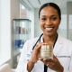 Dermatologist holding an anti-aging face cream jar in a Washington clinic.